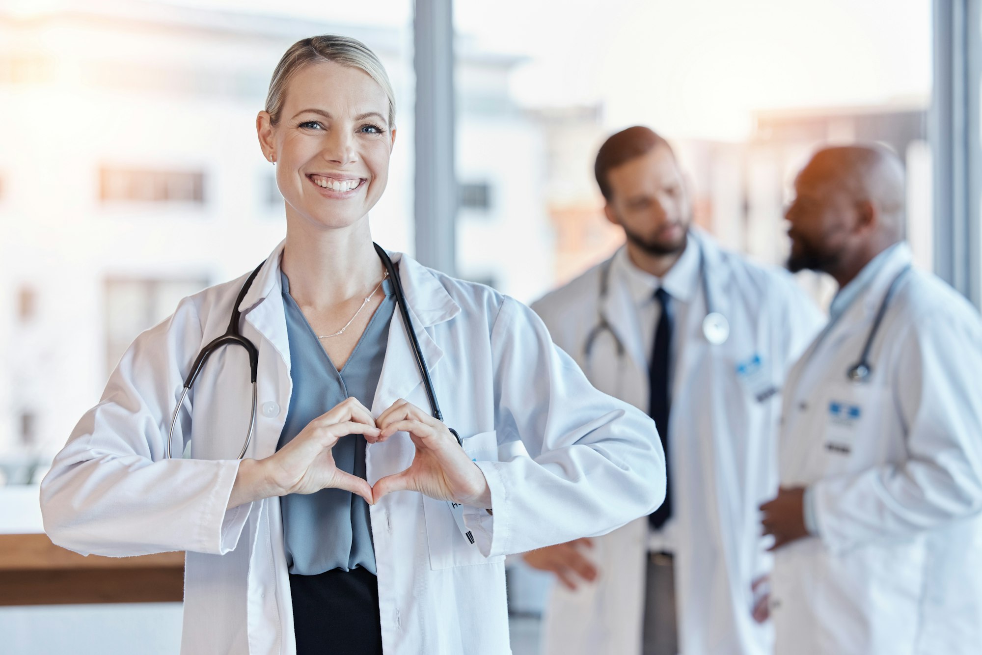 Healthcare, heart and hands with portrait of doctor in hospital for medical, support and kindness.