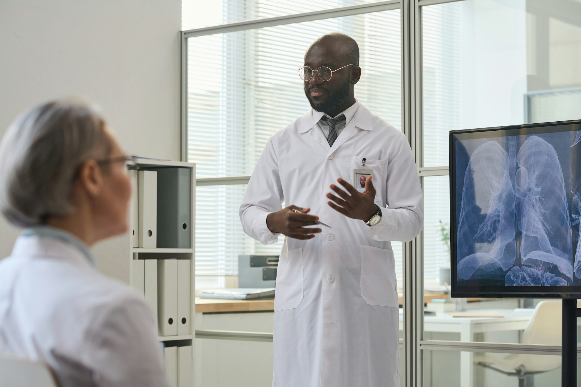 Doctor presenting x-ray image of lungs to his colleagues